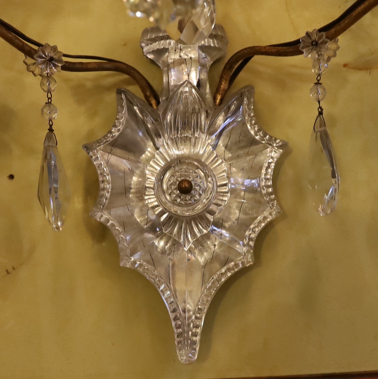 An early 20th century French gilt metal and Baccarat crystal triple branch wall light, height 68cm. width 36cm
